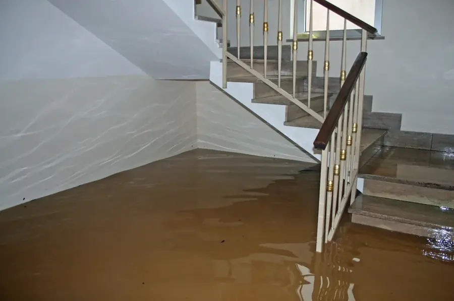 Restoration technicians extracting standing water from a flooded Orem home