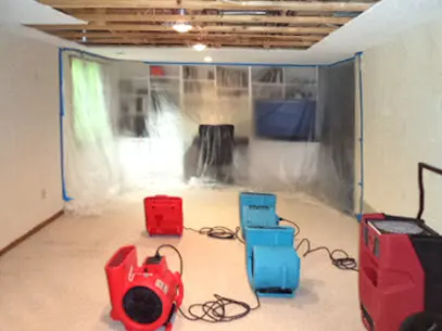 Restoration crew running drying equipment in a large Orem commercial space