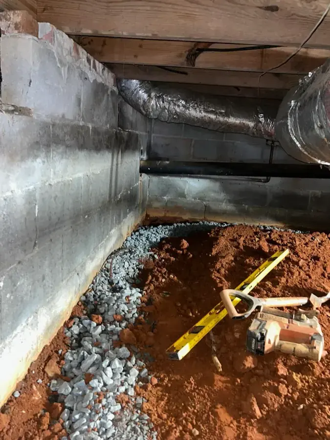 Water pooling around a failed sump pump in a Utah Valley basement