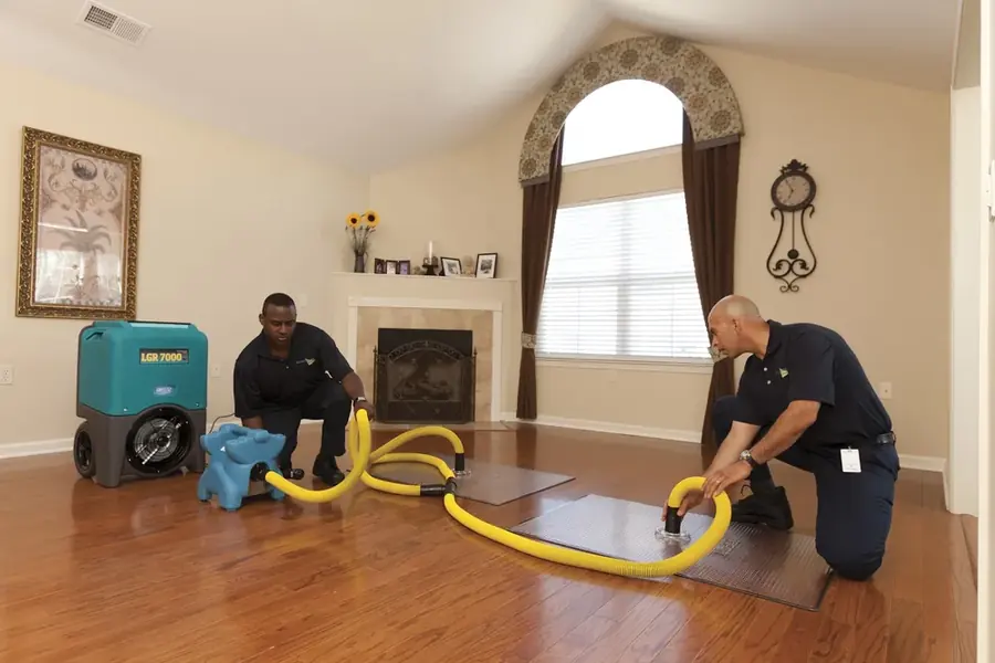 Extraction wand pulling standing water off a flooded Orem floor